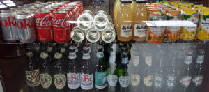 Shelves of beer bottles and assorted soft drinks