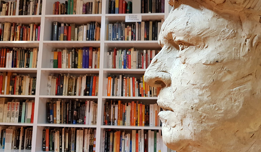The Milton Hebald bust of Anthony Burgess amid Anthony Burgess's book collection